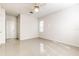 Bright bedroom with a ceiling fan, light neutral walls, and tile flooring for a modern, clean aesthetic at 13304 Sanctuary Cove Dr # 303, Temple Terrace, FL 33637