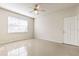 Bedroom featuring tile flooring, ceiling fan, window, and exterior door at 13304 Sanctuary Cove Dr # 303, Temple Terrace, FL 33637