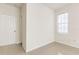 Neutral-toned bedroom featuring a window for natural light, light walls, and tile flooring for a sleek look at 13304 Sanctuary Cove Dr # 303, Temple Terrace, FL 33637