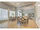 Bright dining area features tile flooring, natural light, and two dining tables for entertaining at 13304 Sanctuary Cove Dr # 303, Temple Terrace, FL 33637