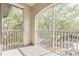 Screened-in balcony with railing overlooking lush greenery creates a relaxing outdoor retreat at 13304 Sanctuary Cove Dr # 303, Temple Terrace, FL 33637