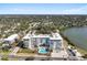 Contemporary condo building with a luxurious pool, ample parking, and nearby body of water at 1020 Sunset Point Rd # 510, Clearwater, FL 33755