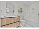 Modern bathroom featuring sleek wood vanity, framed mirror, and a glass-enclosed shower/tub combination at 1020 Sunset Point Rd # 510, Clearwater, FL 33755