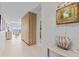 Hallway with light tile flooring leading to the living area, enhanced by stylish decor at 1020 Sunset Point Rd # 510, Clearwater, FL 33755