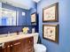 Bathroom featuring a dark vanity, mirror and beautiful floral wall art at 110 Aspen Cir, Seminole, FL 33777