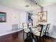 Dining room with glass table, modern chandelier, and hardwood flooring at 110 Aspen Cir, Seminole, FL 33777