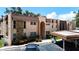 Condo building with tan stucco, decorative stone accents, and covered parking in front at 110 Aspen Cir, Seminole, FL 33777