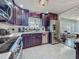 Kitchen features stainless steel appliances, dark wood cabinets, marble tile flooring, and a window overlooking the backyard at 110 Aspen Cir, Seminole, FL 33777