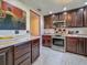 Kitchen featuring dark wood cabinets, marble tile flooring, stainless steel appliances, and modern lighting at 110 Aspen Cir, Seminole, FL 33777
