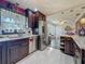 Kitchen view featuring stainless steel appliances, dark wood cabinets, marble tile flooring, and an open layout at 110 Aspen Cir, Seminole, FL 33777