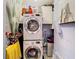 Laundry room features a stacked washer and dryer, and white overhead cabinets at 110 Aspen Cir, Seminole, FL 33777