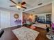 Comfortable living room with ceiling fan flowing into cozy den and entertainment area at 110 Aspen Cir, Seminole, FL 33777