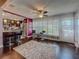 Inviting living room features hardwood floors, modern fan, and opens to kitchen with bar seating at 110 Aspen Cir, Seminole, FL 33777