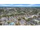 Panoramic aerial perspective of residential neighborhood with trees, pools, and varied housing types at 1142 84Th N Ter # C, St Petersburg, FL 33702