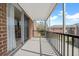 Covered porch with metal railing, exterior brick, and view of surrounding outdoor landscape at 1142 84Th N Ter # C, St Petersburg, FL 33702