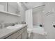 Bright bathroom featuring a tub with shower, white vanity with grey counter, and neutral wall color at 1142 84Th N Ter # C, St Petersburg, FL 33702