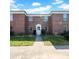 Charming red brick building featuring a classic white door and ample natural light from many windows at 1142 84Th N Ter # C, St Petersburg, FL 33702
