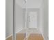 Entryway with a mirrored closet, neutral tile floors and natural-colored rug at 1142 84Th N Ter # C, St Petersburg, FL 33702