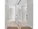 Bright hallway with neutral tile floors and a mirrored closet, adding depth to the space at 1142 84Th N Ter # C, St Petersburg, FL 33702