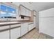 Functional kitchen with ample counter space, white cabinets, and modern appliances at 1142 84Th N Ter # C, St Petersburg, FL 33702