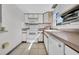 White kitchen featuring appliances and tile flooring at 1142 84Th N Ter # C, St Petersburg, FL 33702