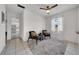 Cozy living room with neutral tile flooring, ceiling fan, and abundant natural light at 1142 84Th N Ter # C, St Petersburg, FL 33702