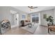 Bright living area with hardwood flooring, a modern ceiling fan, and access to the outdoor balcony at 1142 84Th N Ter # C, St Petersburg, FL 33702