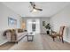 Cozy living space with wood-look floors, a modern ceiling fan, and access to the outdoor balcony at 1142 84Th N Ter # C, St Petersburg, FL 33702