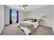 Serene bedroom featuring a ceiling fan, neutral carpet and a large window at 1142 84Th N Ter # C, St Petersburg, FL 33702