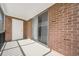 Enclosed porch showing exterior brick, a sliding glass door, and white painted door at 1142 84Th N Ter # C, St Petersburg, FL 33702