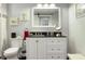 Stylish bathroom with a modern vanity, decorative mirror, and tiled shower area at 1213 Bay Club Cir, Tampa, FL 33607