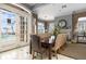 Elegant dining room with views of the pool from French doors, seating eight guests, and a decorative fireplace at 1213 Bay Club Cir, Tampa, FL 33607