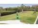 A beautiful community green space with pet waste station and seating surrounded by tropical vegetation at 1213 Bay Club Cir, Tampa, FL 33607