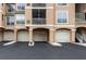Multi-unit building with garages, neutral toned facade, and well-maintained landscaping at 1213 Bay Club Cir, Tampa, FL 33607