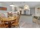 Open kitchen and dining area with stainless appliances, granite counters, and wood floors at 1213 Bay Club Cir, Tampa, FL 33607