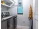 Modern laundry room with front loading washer, dryer, and charming decor at 1213 Bay Club Cir, Tampa, FL 33607