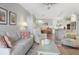 Bright living room with hardwood floors, comfortable seating, and an open layout to the kitchen at 1213 Bay Club Cir, Tampa, FL 33607