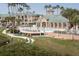 Beautiful community pool with lounge seating and ocean views surrounded by elegant condos and tropical plants at 1213 Bay Club Cir, Tampa, FL 33607
