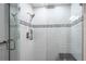 Contemporary tiled shower featuring glass enclosure, rainfall showerhead, and convenient corner shelving at 1213 Bay Club Cir, Tampa, FL 33607