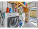 Laundry area with washer and dryer, storage shelves, and utility equipment at 1272 80Th N Ave, St Petersburg, FL 33702