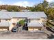 Aerial view of the townhouse complex showing the complex's metal roof, reserved parking, and landscaping at 13003 Lorna Pl, Tampa, FL 33618