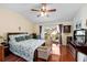 Spacious main bedroom with a balcony and hardwood floors at 13003 Lorna Pl, Tampa, FL 33618