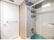 Shower area with glass sliding door and tiled walls, complemented by a white door and chrome fixtures at 1421 Monte Carlo Dr, Clearwater, FL 33764