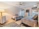 Cozy bedroom featuring twin beds, neutral decor, a ceiling fan, and ample natural light at 1421 Monte Carlo Dr, Clearwater, FL 33764