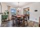 Dining room with natural light, wood floors, traditional table and chairs, and view into living room at 1421 Monte Carlo Dr, Clearwater, FL 33764