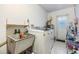 Practical laundry room with washer, sink, dryer, and easy access to the outdoors at 1421 Monte Carlo Dr, Clearwater, FL 33764