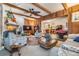 Inviting living room featuring wood accents, a ceiling fan, cozy furniture, and an open view into the dining area at 1421 Monte Carlo Dr, Clearwater, FL 33764