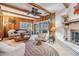 Warm living room with a brick fireplace, wood-paneled walls, and comfortable seating at 1421 Monte Carlo Dr, Clearwater, FL 33764
