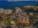 Aerial view of luxury waterfront condos, a pond, and a swimming pool at 150 Belleview Blvd # 307, Belleair, FL 33756
