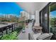 This balcony includes comfortable patio furniture with views of the city at 150 Belleview Blvd # 307, Belleair, FL 33756